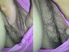 Hairy and wet pussy of a Desi cougar is filmed from a close up until she XXX
